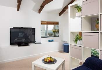 The open plan sitting-area has a huge TV, enjoy a movie together for a quiet night in.