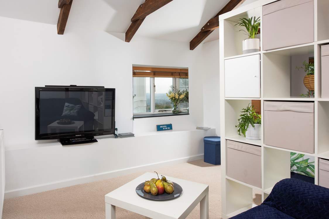 The open plan sitting-area has a huge TV, enjoy a movie together for a quiet night in.