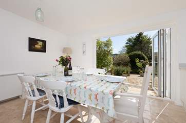 The gorgeous open plan kitchen/dining-room has bi-fold doors to a very sheltered and private feeling garden at the back of the cottage.