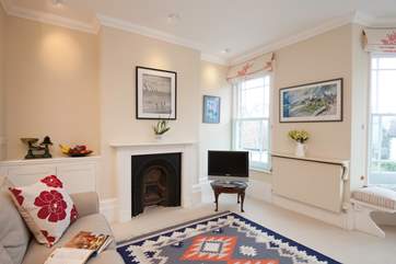 There is plenty of character in the sitting-room with bay windows and an ornamental fireplace.