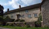 The farmhouse has an enclosed front garden and plenty of parking either to the side of the little no through lane or in the driveway to the side of the house. - Thumbnail Image