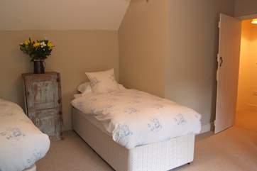 The twin bedroom, as with all the rooms, is peacefully decorated.