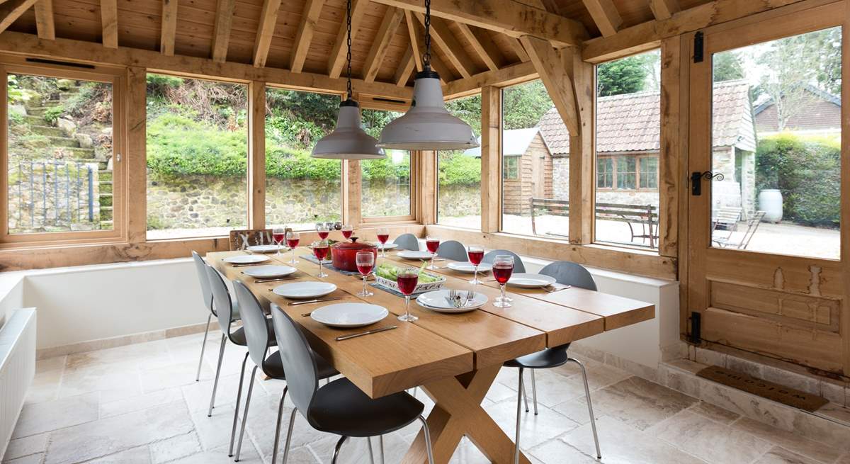 This light-filled oak-framed dining-room seats all 12  guests easily. There is direct access outside too.