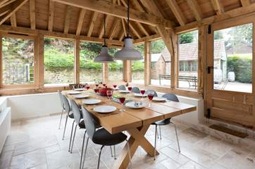 This light-filled oak-framed dining-room seats all 12 guests easily. There is direct access outside too.