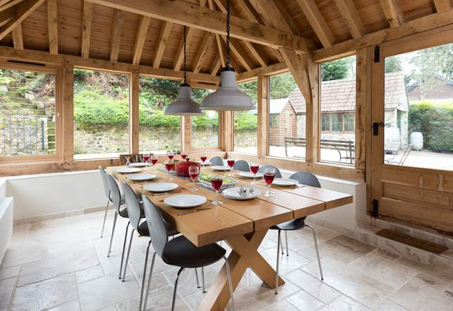This light-filled oak-framed dining-room seats all 12  guests easily. There is direct access outside too.
