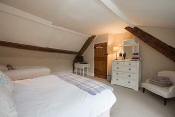 Linked by a door to the master bedroom is this family room with a double and a single bed. This room also has separate access from the central staircase.