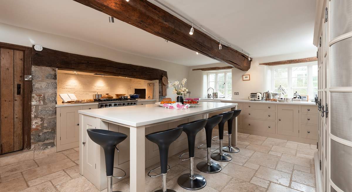 The farmhouse has a stunning contemporary kitchen with a range cooker, a huge sociable island and gorgeous stone flooring.