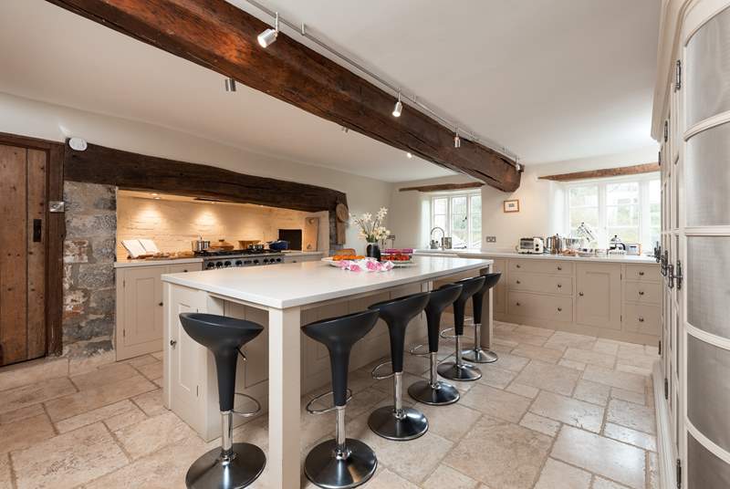 The farmhouse has a stunning contemporary kitchen with a range cooker, a huge sociable island and gorgeous stone flooring.