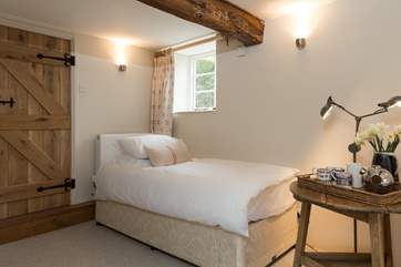 The other single bed is in the corner of the lower ground floor bedroom.