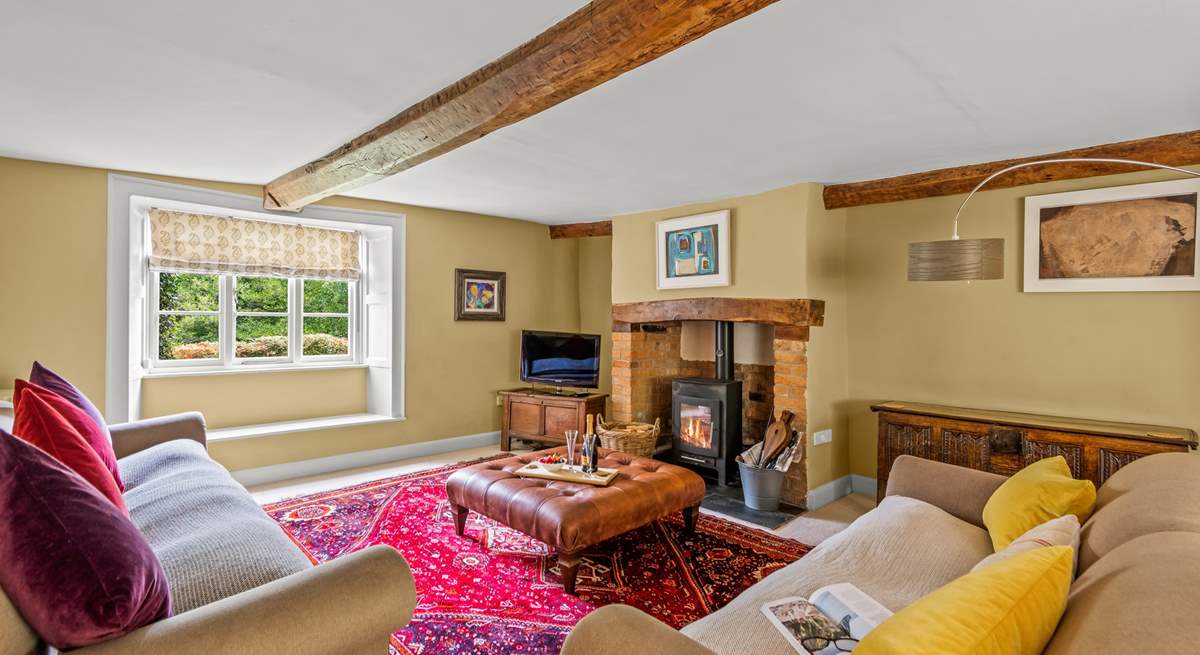 This is the sitting-room with a wood-burning stove, deep comfortable sofas and a lovely warm atmosphere.