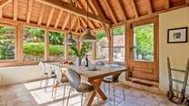 This light-filled oak-framed dining-room seats all 12  guests easily. There is direct access outside too.