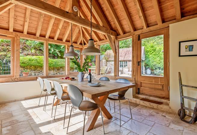 This light-filled oak-framed dining-room seats all 12  guests easily. There is direct access outside too.