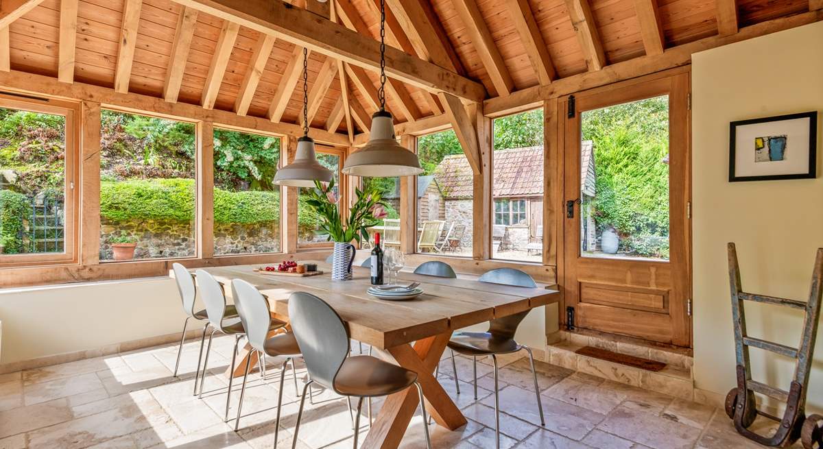 This light-filled oak-framed dining-room seats all 12  guests easily. There is direct access outside too.