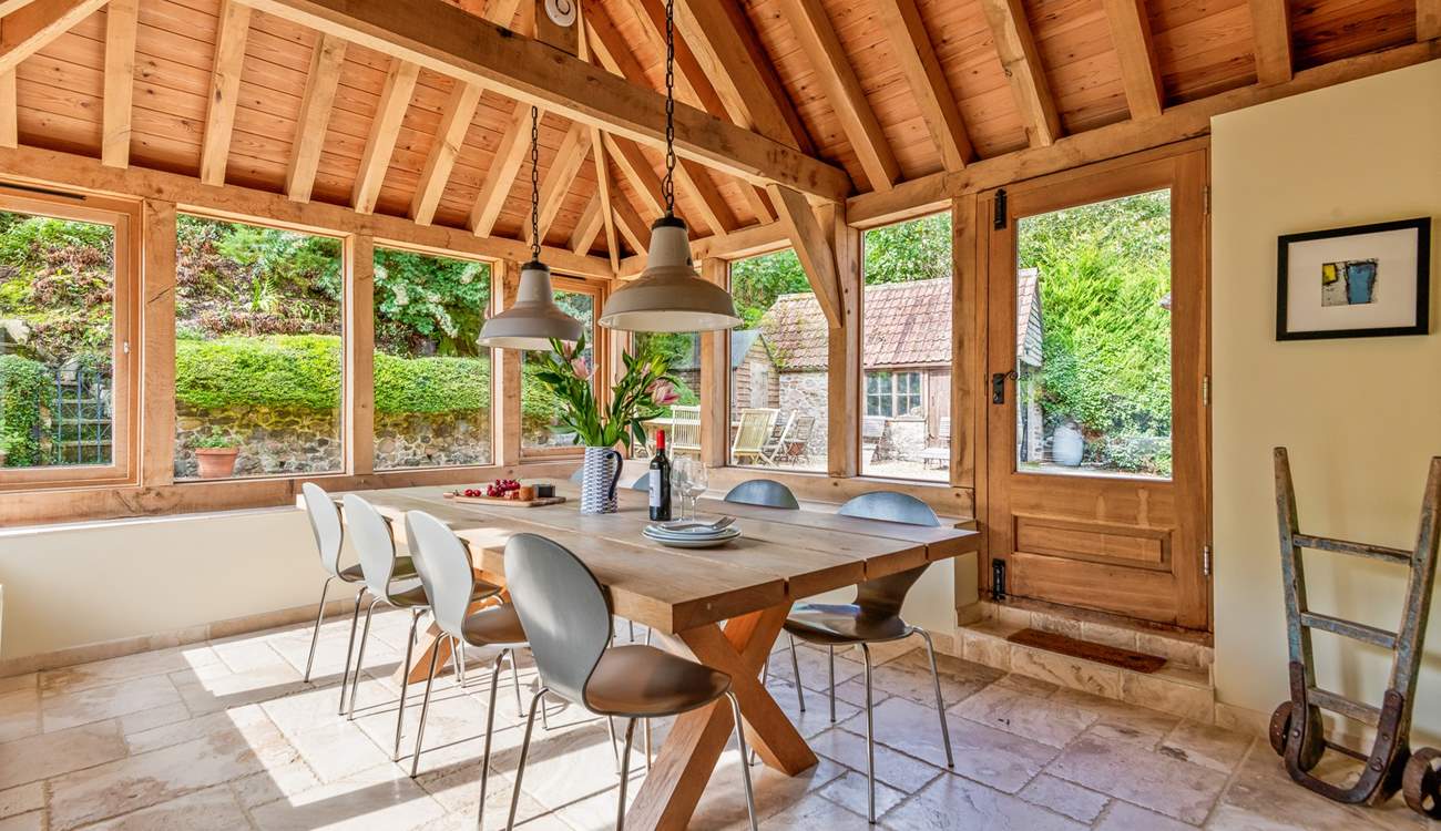 This light-filled oak-framed dining-room seats all 12  guests easily. There is direct access outside too.