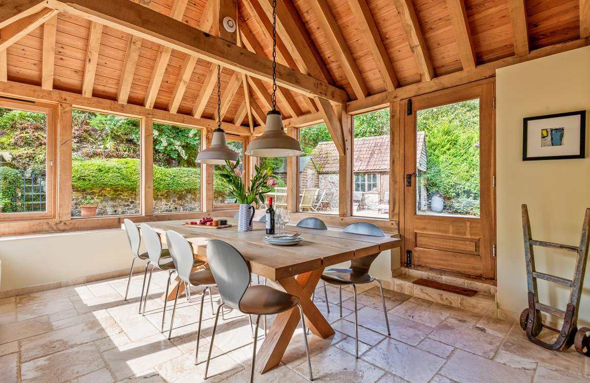 This light-filled oak-framed dining-room seats all 12  guests easily. There is direct access outside too.