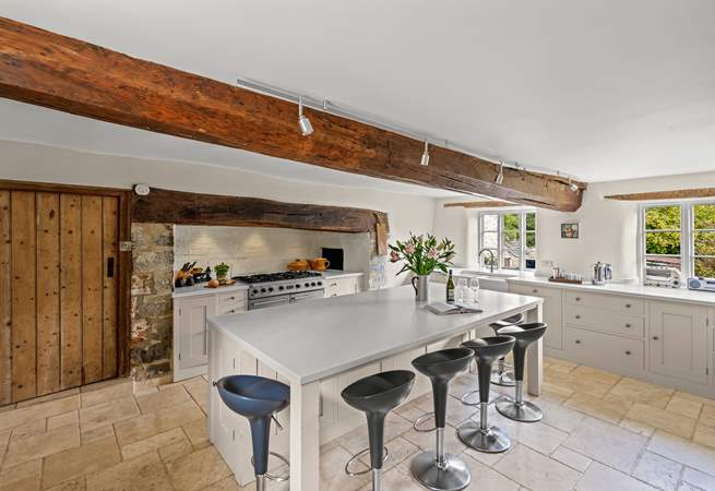 The farmhouse has a stunning contemporary kitchen with a range cooker, a huge sociable island and gorgeous stone flooring.