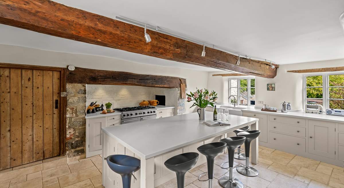 The farmhouse has a stunning contemporary kitchen with a range cooker, a huge sociable island and gorgeous stone flooring.