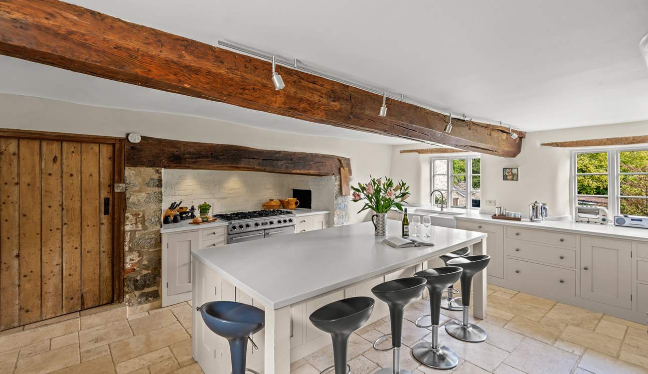 The farmhouse has a stunning contemporary kitchen with a range cooker, a huge sociable island and gorgeous stone flooring.