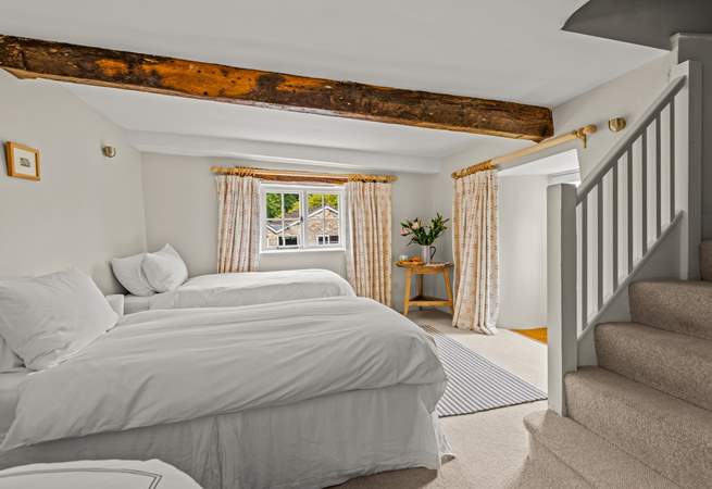 This is the lower ground floor bedroom. This room sleeps 3 guests in 3 single beds, two of which can be pushed together to create the effect of a double. They are not 'zip and link'.