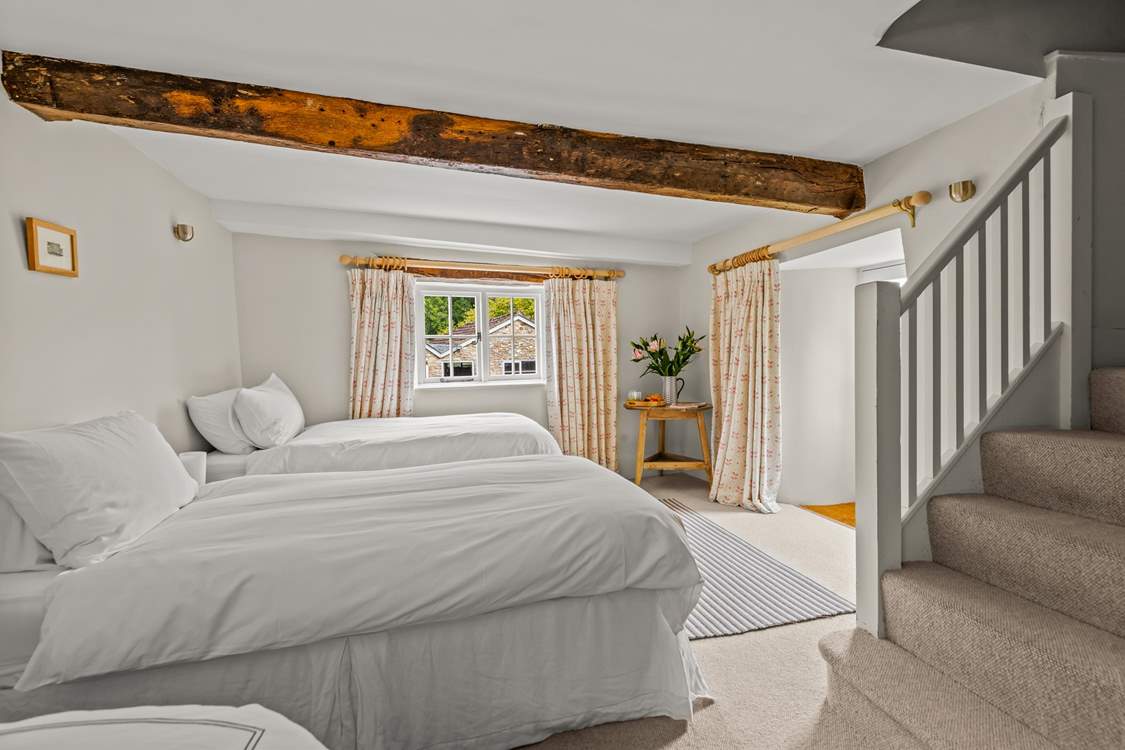 This is the lower ground floor bedroom. This room sleeps 3 guests in 3 single beds, two of which can be pushed together to create the effect of a double. They are not 'zip and link'.