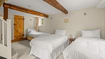 The other single bed is in the corner of the lower ground floor bedroom.