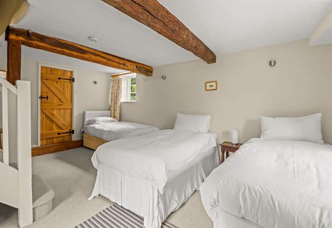 The other single bed is in the corner of the lower ground floor bedroom.