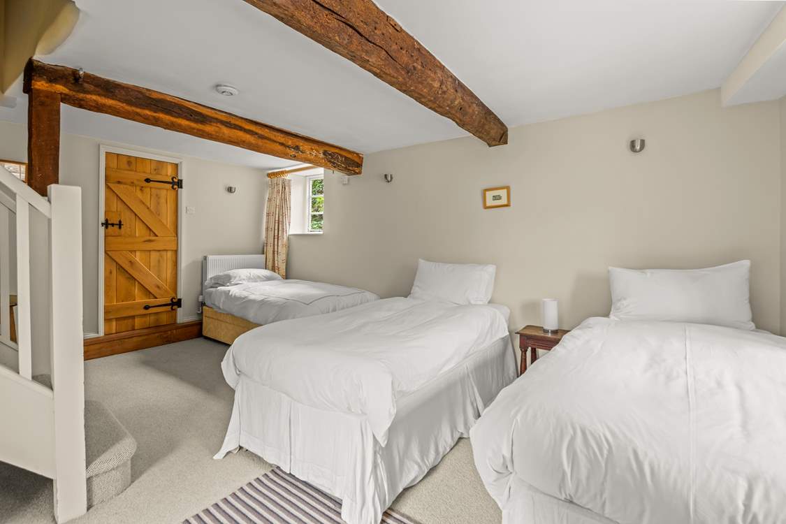The other single bed is in the corner of the lower ground floor bedroom.