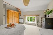 The outlook from this bedroom is at the near end of the farmhouse as you approach down the lane.