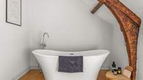 The very stylish family bathroom -  where the bath proudly sits one step up from the rest of the room.