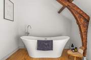 The very stylish family bathroom (the bath is up one step from the rest of the bathroom) is a brand new addition to the farmhouse.