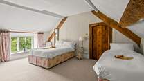 Linked by a door to the main bedroom is this family room with a double and a single bed. This room also has separate access from the central staircase.