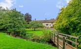 As well as the gardens around the farmhouse there is a small meadow and a little bridge over the river (please supervise children at all times). - Thumbnail Image