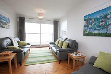 As you relax in the sitting-room, open up the patio doors out to the balcony and let the summer air come through.