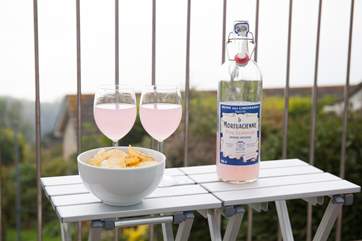 Take a drink out onto the balcony.