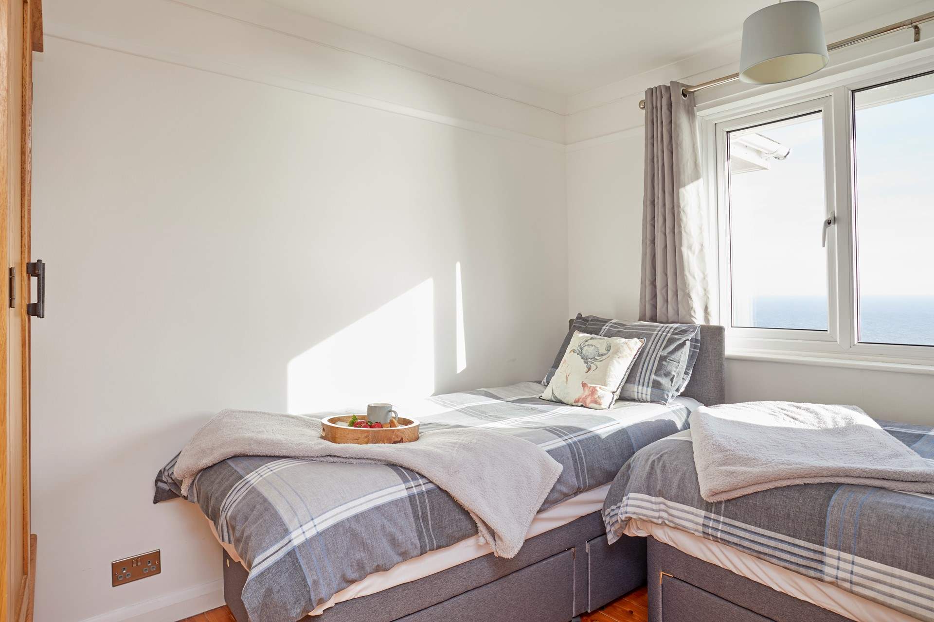 The second twin bedroom with views of the sea.