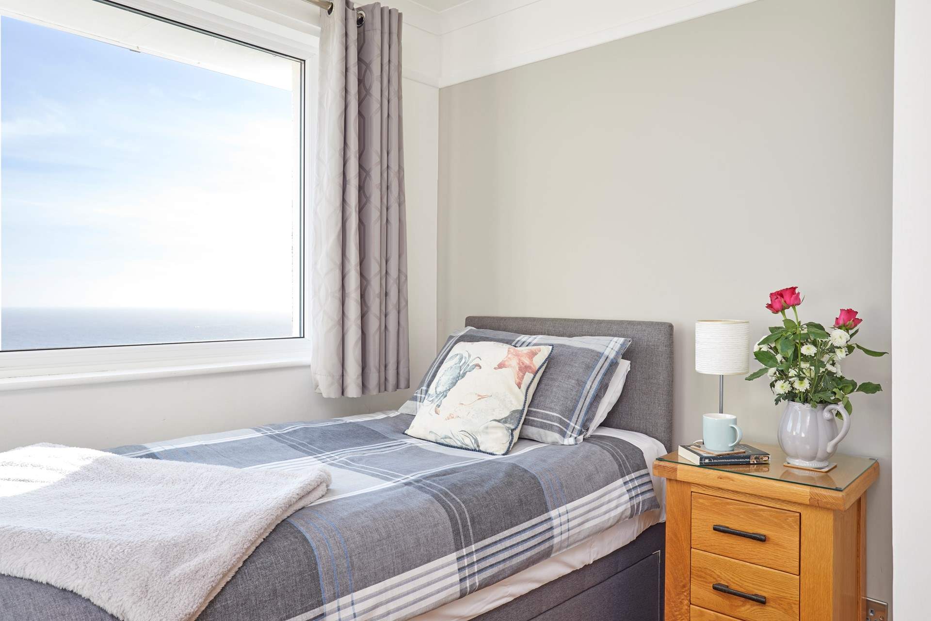 The twin bedroom with views of the sea.