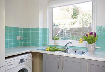 The utility-room is an additional space with laundry appliances as well as an extra sink and worktop to arrange flowers.