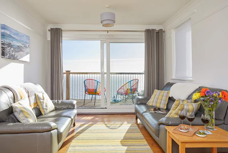 The sitting-room with access to the patio and garden has a fantastic view of the English Channel.