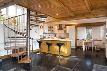 The spiral staircase provides a divide between the kitchen/dining-areas and the sitting-area.