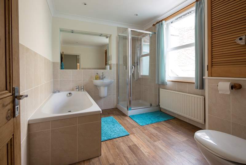 Large family bathroom offering a bath and shower cubicle.