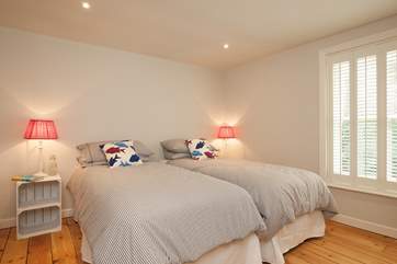 The beautifully decorated and spacious twin bedroom has views over the front garden.