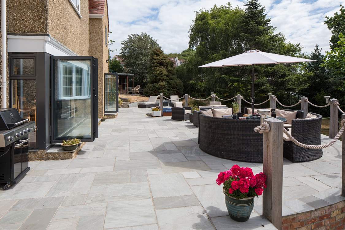 A gas barbecue allows you spend your summer days lounging on the terrace. Steep steps lead down to the enclosed lawn.