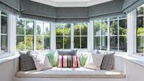 Take a moment to curl up in the sitting-room window seat.