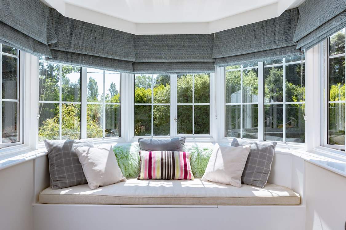 Take a moment to curl up in the sitting-room window seat.