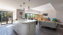 This spacious family home has a fabulous open plan space, with tri-fold doors onto the terrace.