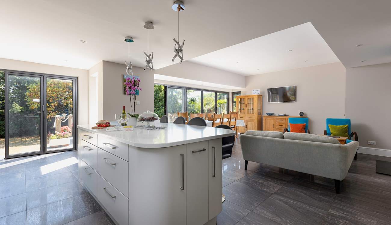 This spacious family home has a fabulous open plan space, with tri-fold doors onto the terrace.