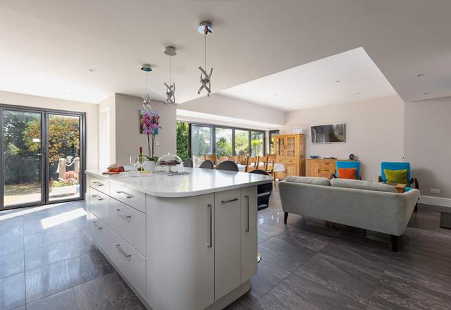 This spacious family home has a fabulous open plan space, with tri-fold doors onto the terrace.