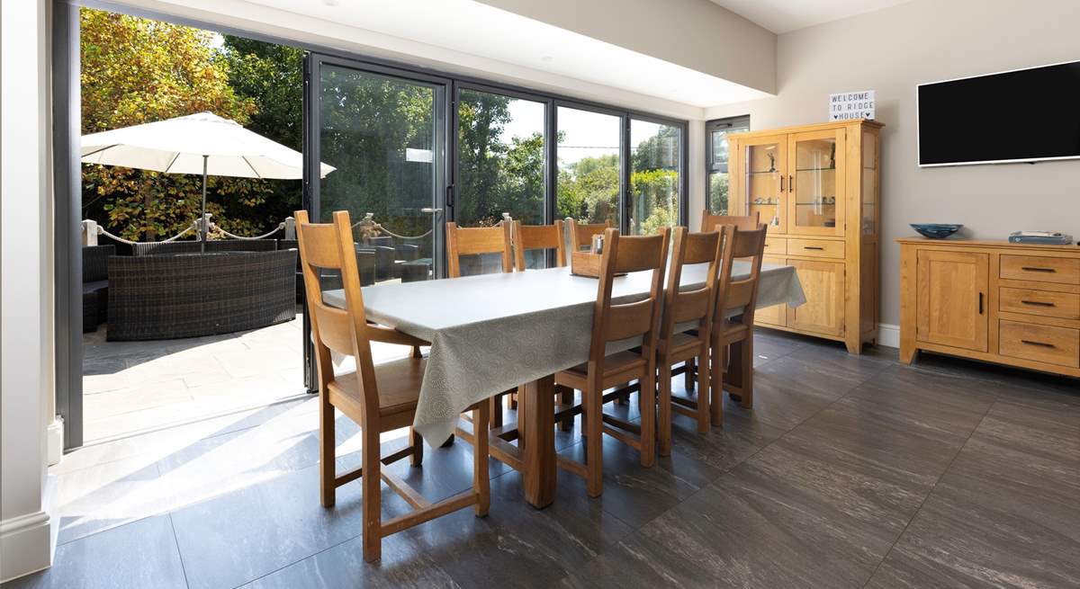 Folding doors open out onto the terrace, bringing the light and sunshine inside