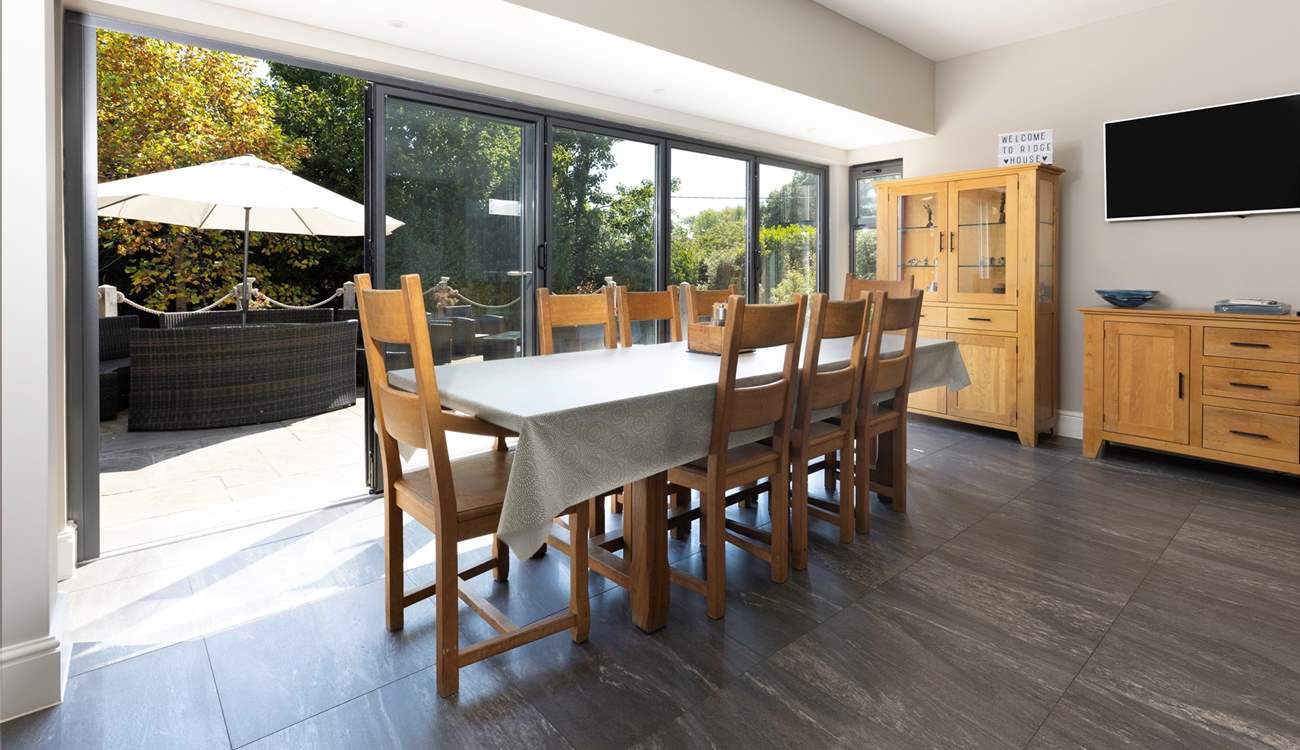 Folding doors open out onto the terrace, bringing the light and sunshine inside