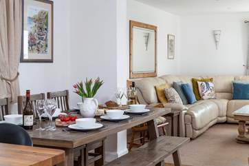 The dining-table has a long bench, and chairs to sit around.